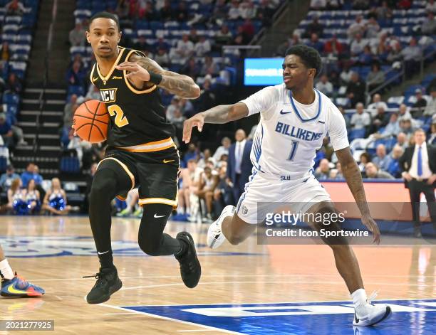 Virginia Commonwealth guard Zeb Jackson drives to the basket as St. Louis guard Clan Medley defends during a college basketball game between the...