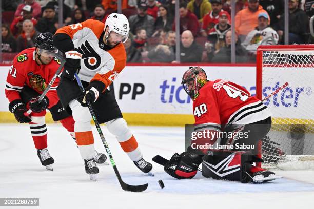 Ryan Poehling of the Philadelphia Flyers attempts to make a shot on goaltender Arvid Soderblom of the Chicago Blackhawks in the first period on...