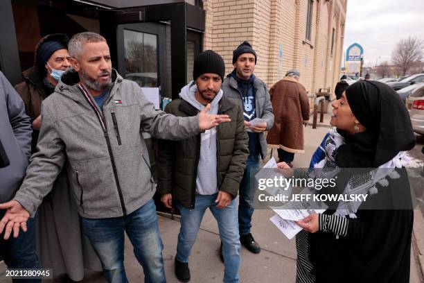 Samra'a Luqman hands out fliers outside of the American Moslem Society Mosque to ask voters not to vote for President Joe Biden after Friday prayers...