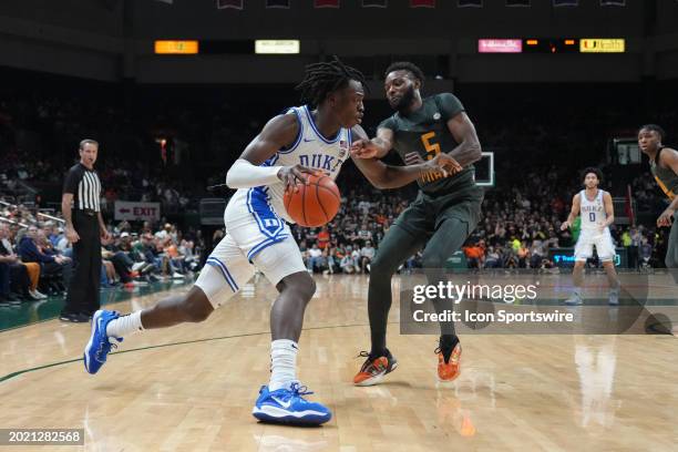 Duke Blue Devils forward Mark Mitchell tires to get past Miami Hurricanes guard Wooga Poplar as he drives to the basket during the game between the...