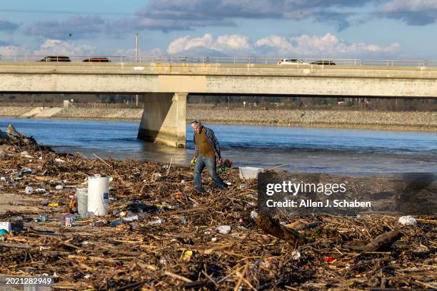 Huntington Beach, CA Following heavy rain in recent days, Sam Hale, of Garden Grove, searches storm runoff debris on the banks of the Santa Ana River...