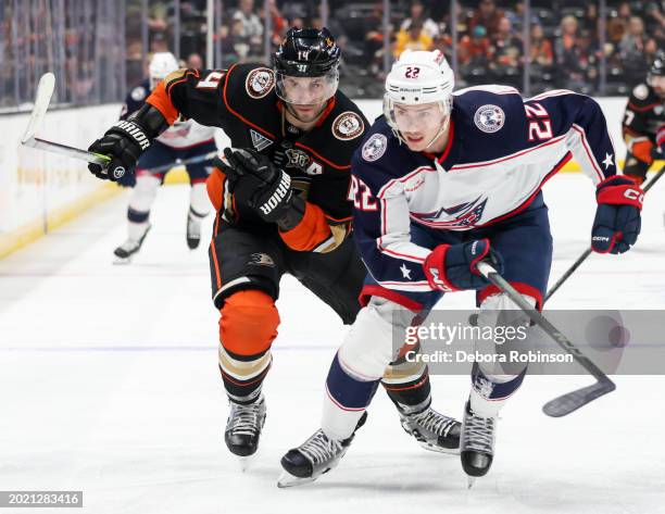 Adam Henrique of the Anaheim Ducks and Jake Bean of the Columbus Blue Jackets battle for position during the first period at Honda Center on February...