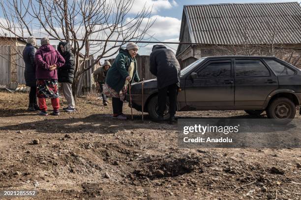 Residents gather next to Kostiantynivka city council worker collecting data from damaged houses after a Russian shelling over Kostiantynivka, Ukraine...