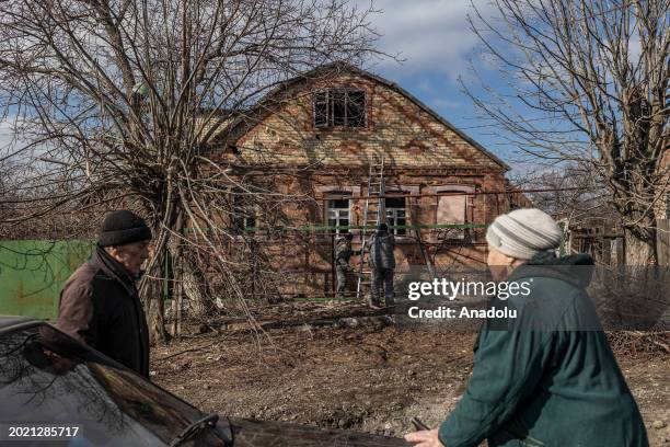 Residents gather next to Kostiantynivka city council worker collecting data from damaged houses after a Russian shelling over Kostiantynivka, Ukraine...