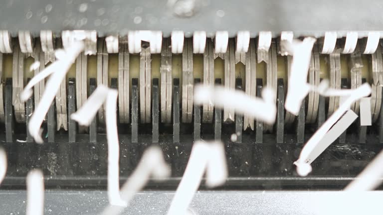 Destrying Copy Machine Teeth of the shredder rotating and destroying paper lorem ipsum text ...