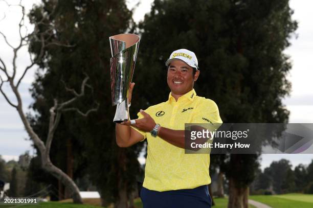 Hideki Matsuyama of Japan poses for a photo with the trophy after putting in to win on the 18th green during the final round of The Genesis...