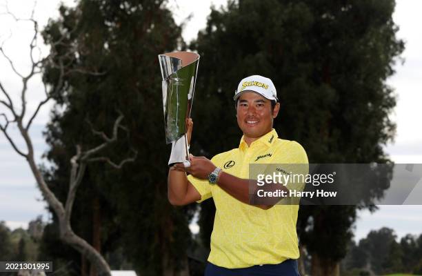 Hideki Matsuyama of Japan poses for a photo with the trophy after putting in to win on the 18th green during the final round of The Genesis...