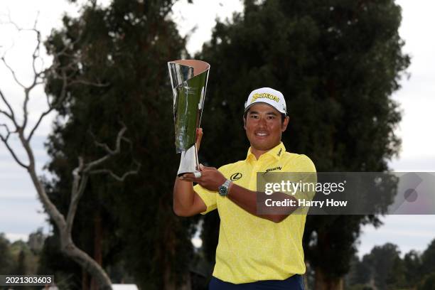 Hideki Matsuyama of Japan poses for a photo with the trophy after putting in to win on the 18th green during the final round of The Genesis...
