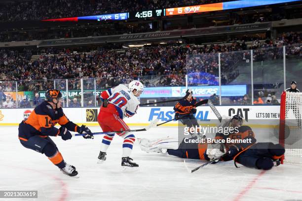 Artemi Panarin of the New York Rangers scores the game-winning goal in overtime past Ilya Sorokin of the New York Islanders during the 2024 Navy...