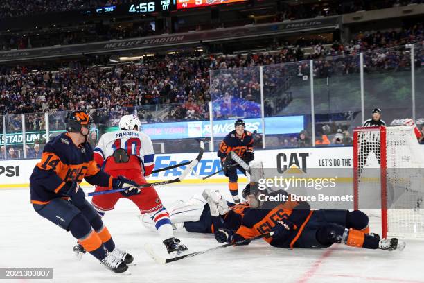 Artemi Panarin of the New York Rangers scores the game-winning goal in overtime past Ilya Sorokin of the New York Islanders during the 2024 Navy...