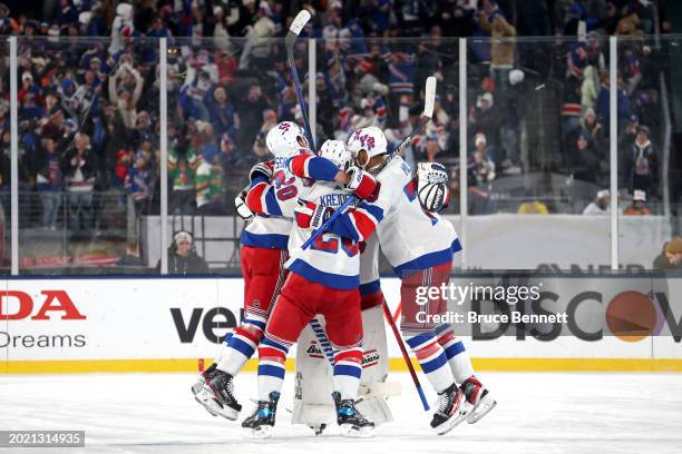 The New York Rangers celebrate their 6-5 overtime win against the New York Islanders during the 2024 Navy Federal Credit Union Stadium Series at...