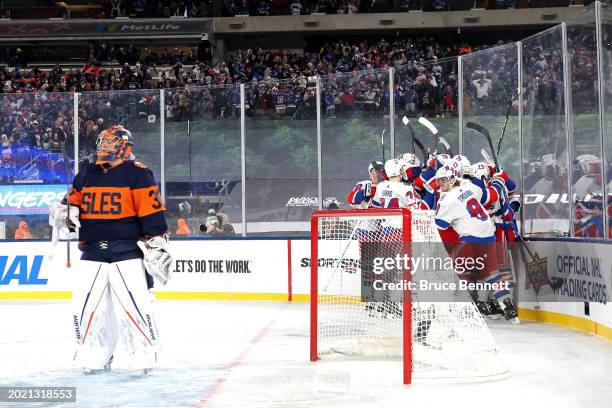 Artemi Panarin of the New York Rangers is congratulated by his teammates after scoring the game-winning goal in overtime past Ilya Sorokin of the New...