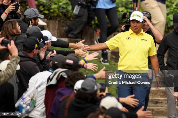 Hideki Matsuyama of Japan celebrates with fans as he walks to the trophy ceremony during the final round of The Genesis Invitational at Riviera...