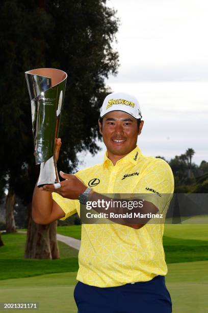 Hideki Matsuyama of Japan poses for a photo with the trophy after putting in to win on the 18th green during the final round of The Genesis...