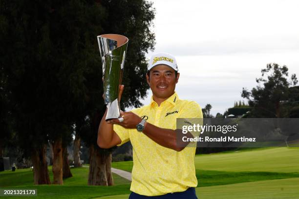 Hideki Matsuyama of Japan poses for a photo with the trophy after putting in to win on the 18th green during the final round of The Genesis...