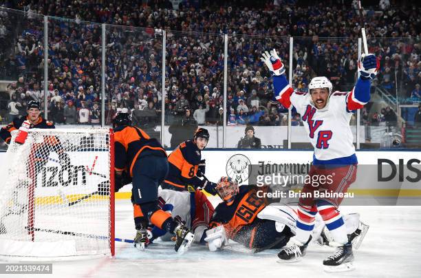 Vincent Trocheck of the New York Rangers reacts after an overtime game-winning goal was scored by teammate Artemi Panarin as Noah Dobson and Ilya...