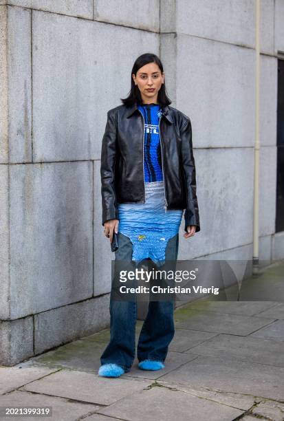 Guest wears black leather jacket, blue Inter Milan shirt, dress outside Conner Ives during London Fashion Week February 2024 on February 18, 2024 in...