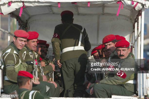 Kurdish Peshmerger officers arrive along a main streets 20 March 2004 in Sulaimaniyah, northern Iraq, on the eve on Noruz, the Kurdish New Year,...