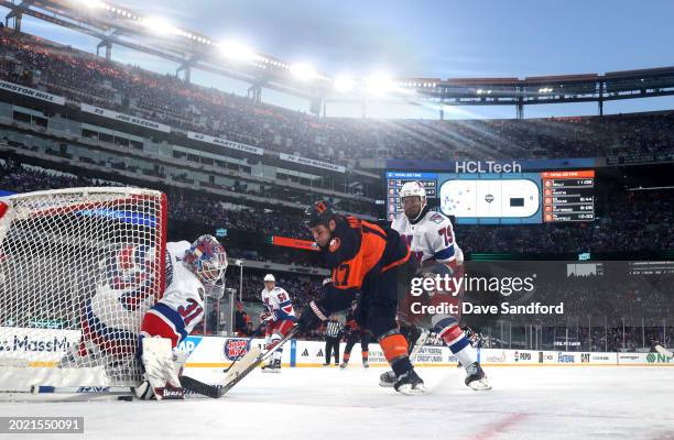 Goaltender Igor Shesterkin of the New York Rangers makes a save on a shot attempt by Matt Martin of the New York Islanders during the first period of...