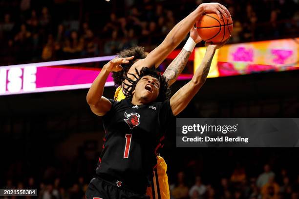 Braeden Carrington of the Minnesota Golden Gophers blocks a shot by Jamichael Davis of the Rutgers Scarlet Knights in the second half at Williams...