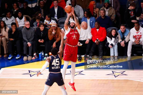 Anthony Davis of the Los Angeles Lakers and Western Conference All-Stars shoots the ball over Donovan Mitchell of the Cleveland Cavaliers and Eastern...