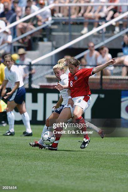 Midfielder Aly Wagner of the United States Women's National Team battles for the ball with defender Rachel McArthur of the England Women's National...