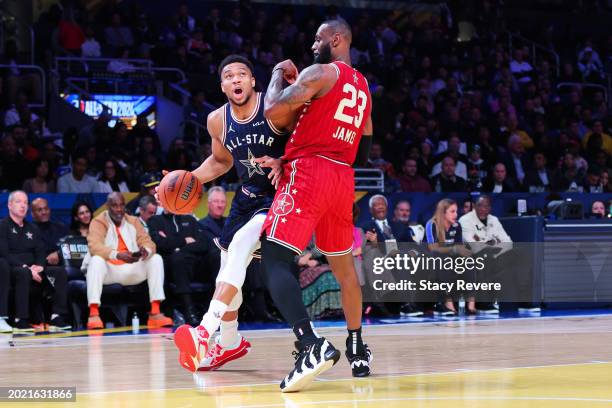 Giannis Antetokounmpo of the Milwaukee Bucks and Eastern Conference All-Stars drives against LeBron James of the Los Angeles Lakers and Western...