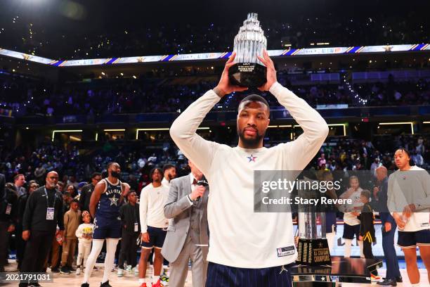 Damian Lillard of the Milwaukee Bucks lifts the Kobe Bryant All-Star MVP trophy during the 2024 NBA All-Star Game at Gainbridge Fieldhouse on...