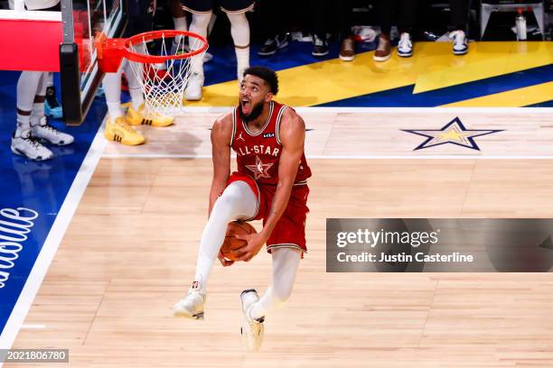 Karl-Anthony Towns of the Minnesota Timberwolves and Western Conference All-Stars drives to the basket against the Eastern Conference All-Stars in...