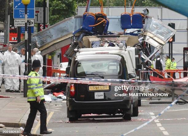 Police forensic officers examine 08 July 2005 the No.30 bus that was torn apart by a bomb on Thursday in Upper Woburn Place, London. Shaken but...
