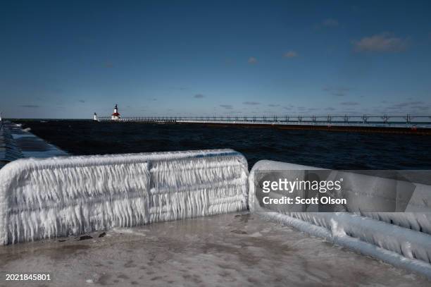 Ice builds up along a pier on Lake Michigan on February 18, 2024 in St. Joseph, Michigan. The Great Lakes shorelines have historically been...