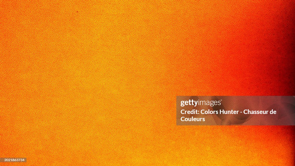 Close-up of bright red and black dots on a bright yellow background. Macro photography of a poster printed in offset in Paris, France. Artificial light (neon) and saturated colors.