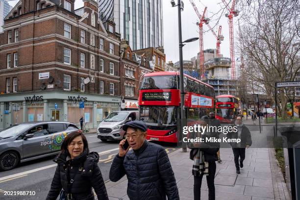 Street scene of pedestrains and buses as Elephant and Castle undergoes it's continued redevelopment on 7th February 2024 in London, United Kingdom....