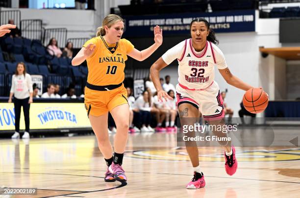 Essence Brown of the George Washington Revolutionaries handles the ball against Nicole Melious of the La Salle Explorers at Charles E. Smith Athletic...