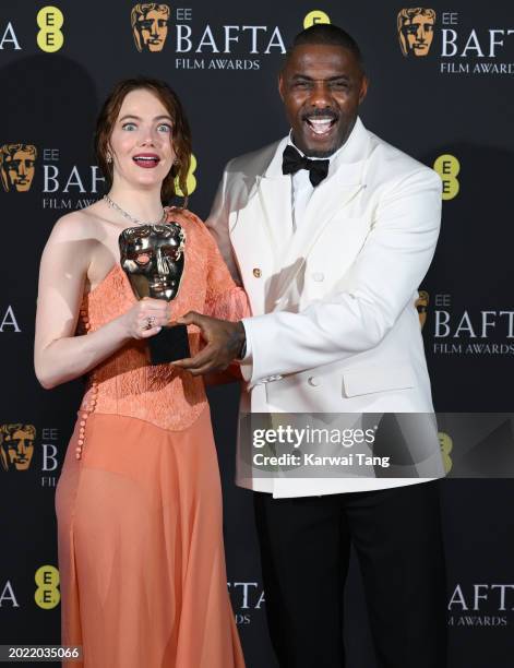 Emma Stone and Idris Elba pose in the Winners Room with the Leading Actress Award during the EE BAFTA Film Awards at The Royal Festival Hall on...