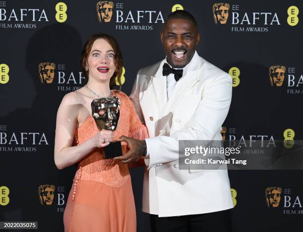 Emma Stone and Idris Elba pose in the Winners Room with the Leading Actress Award during the EE BAFTA Film Awards at The Royal Festival Hall on...