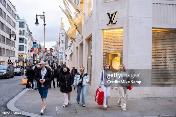 People passing the Louis Vuitton store on Bond Street which has seen a recent drop in demand for luxury goods and with some stores deciding to move...