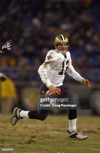 Quarterback Jake Delhomme of the New Orleans Saints scrambles for yardage against the Baltimore Ravens at Ravens Stadium on December 8, 2002 in...