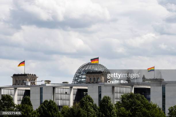 deutscher bundestag - the reichstag building with german- and lgbtq+ - flags (german parliament building) - berlin, germany - berlin gay pride stock pictures, royalty-free photos & images