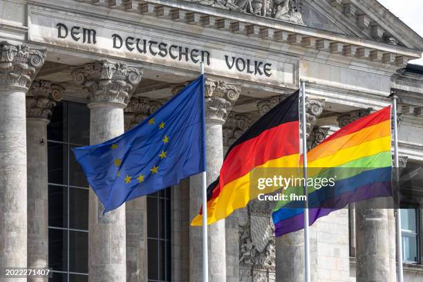 deutscher bundestag - the reichstag building with eu-, german- and lgbtq+ - flags (german parliament building) - berlin, germany - berlin gay pride stock pictures, royalty-free photos & images