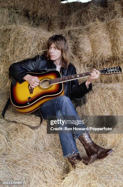 Welsh singer, musician and guitarist Dave Edmunds playing an Eko acoustic guitar in a hay barn in England circa 1971. Dave Edmunds was formerly...