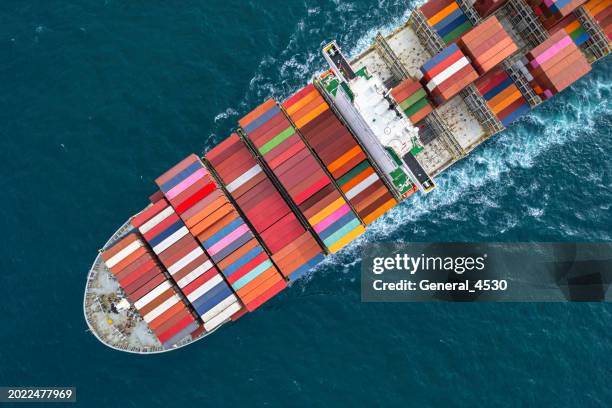 aerial top view container cargo ship full speed with beautiful wave pattern carrier container on the sea for business logistic. - full elevator stock pictures, royalty-free photos & images