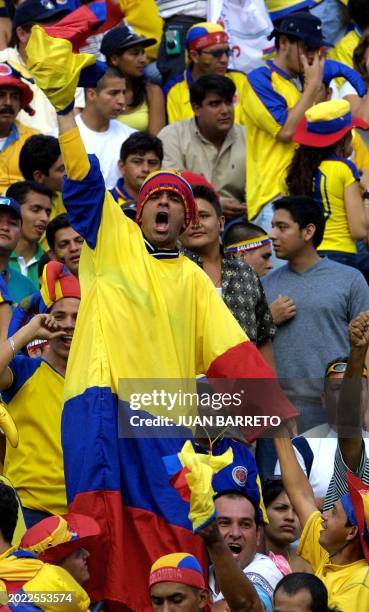 Colombian fan dressed in his country flag colors shouts to support his team, while waiting for the beginning of the soccer match against Venezuela,...