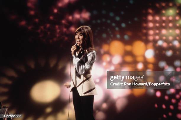 English singer and actress Anita Harris performs on the set of a pop music television show in London circa 1970.