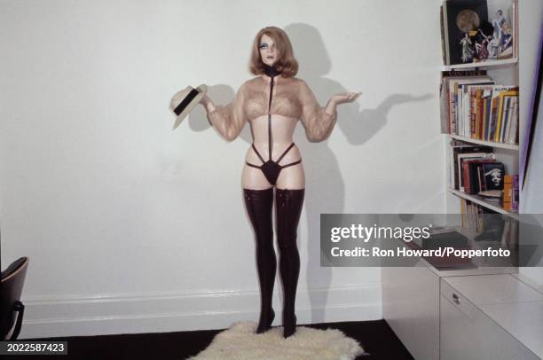 View of a living room featuring an erotic Hatstand sculpture by English pop artist Allen Jones, London, circa 1970. The Hatstand sculpture was...