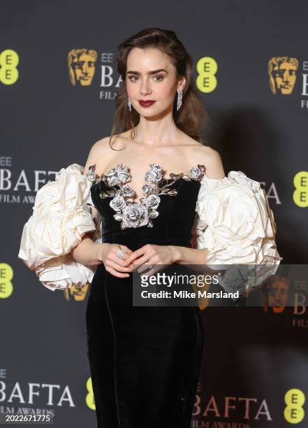 Lily Collins poses in the winners room at the 2024 EE BAFTA Film Awards at The Royal Festival Hall on February 18, 2024 in London, England.