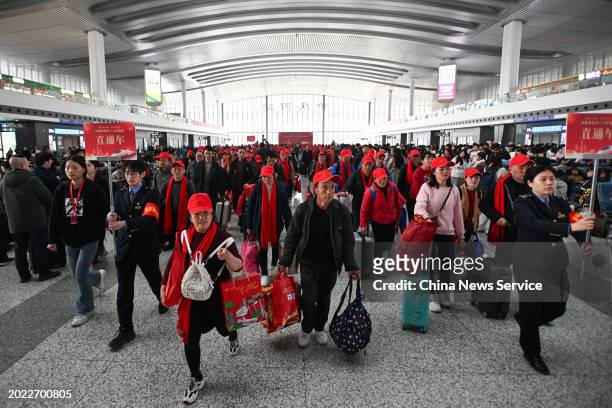 Migrant workers walk to the platform to board train G3729 at Chongqing West Railway Station on February 19, 2024 in Chongqing, China. Train G3729, a...