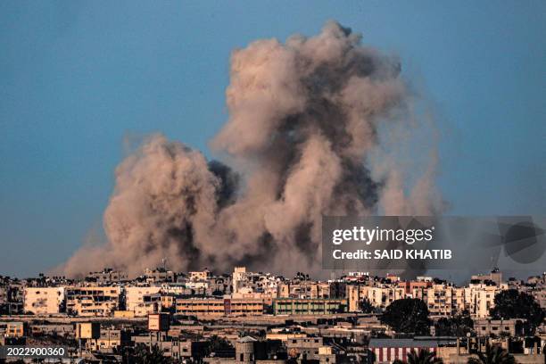 This picture taken from Rafah in the southern Gaza Strip shows smoke billowing during Israeli bombardment on Khan Yunis on February 22 amid...