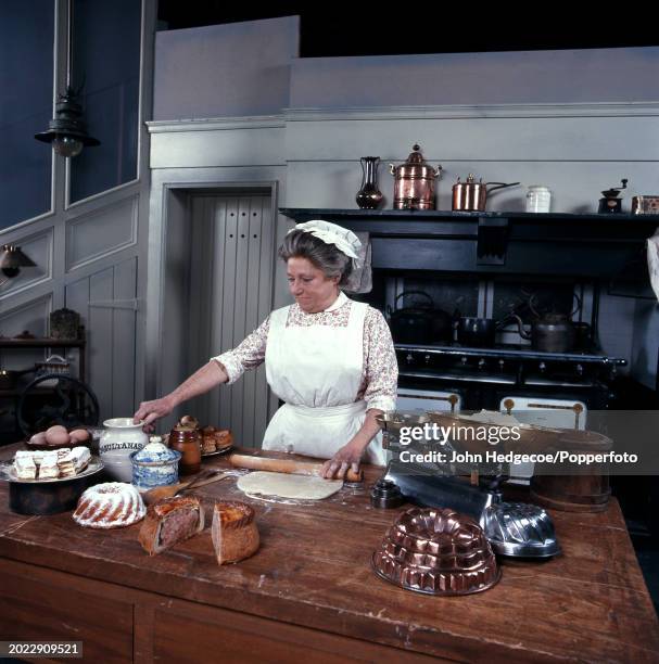 English actress Angela Baddeley dressed in character as the cook Mrs Bridges on the set of the period drama television series Upstairs, Downstairs in...