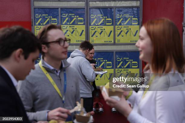 People eat Ukrainian food outside the venue of Cafe Kyiv, a one-day event bringing together panel discussions on topics relating to Russia's ongoing...